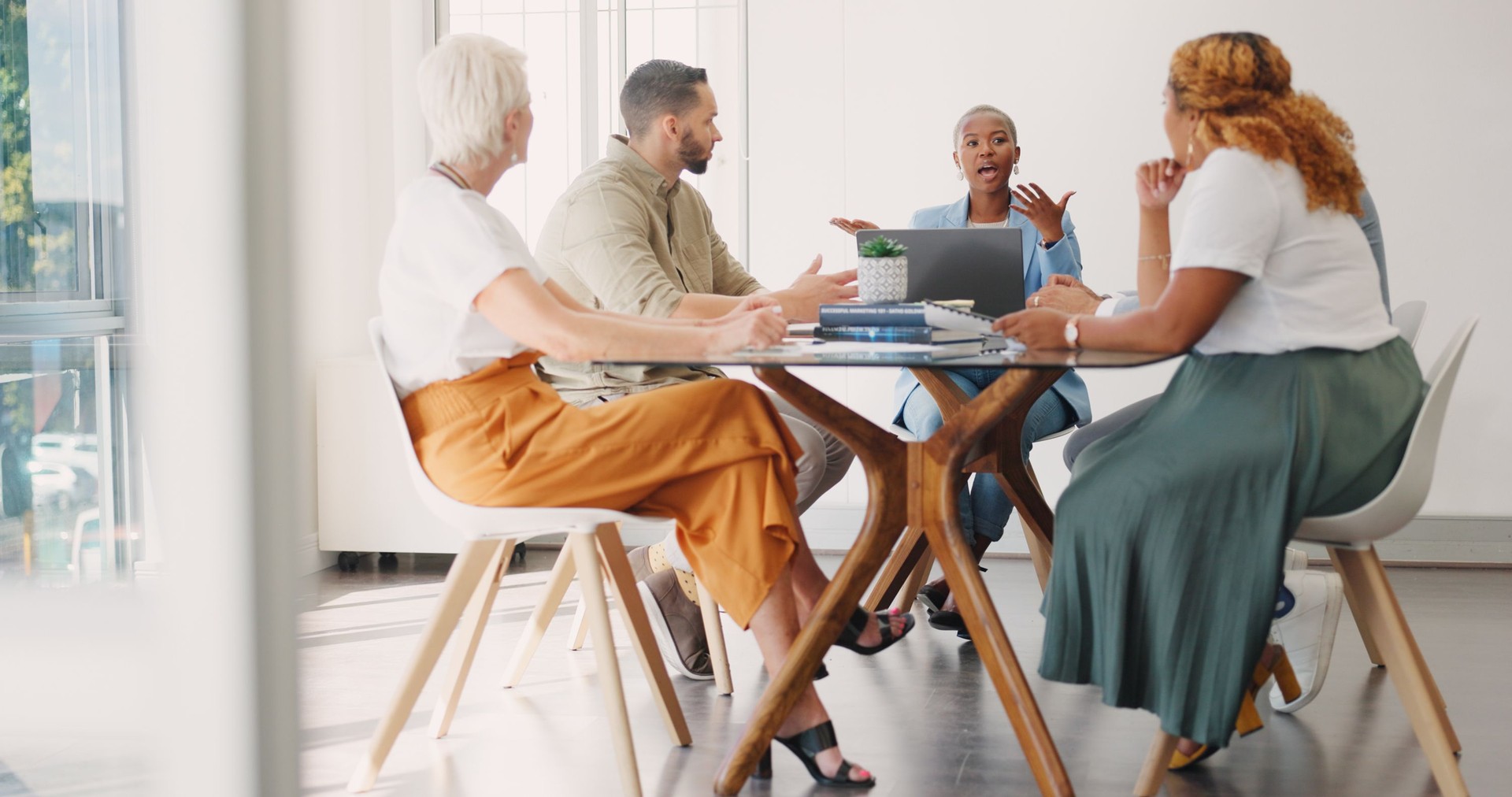 Black woman, leadership and meeting in creative business, planning or collaboration in team startup ay office. African female person talking to employees or training staff in discussion at workplace