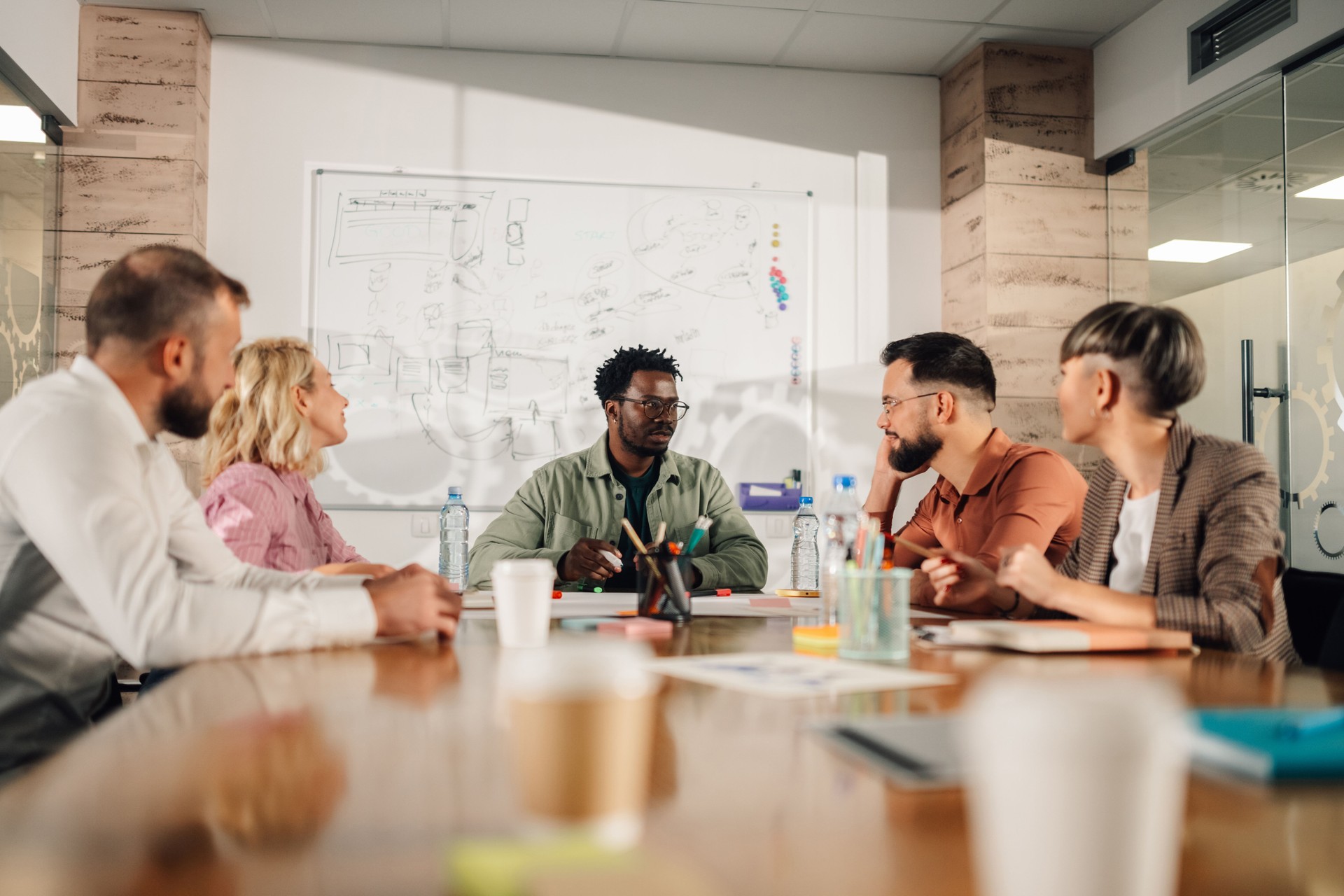 Marketing professionals collaborating on project during meeting in modern office